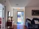 Inviting foyer with hardwood floors, a vintage table and easy access to the rest of the home at 5518 Prosperity View Dr, Charlotte, NC 28269