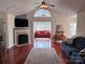 Spacious living room boasts a fireplace, gleaming hardwood floors, and a large arched window at 5518 Prosperity View Dr, Charlotte, NC 28269