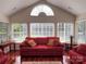 Bright sunroom with hardwood floors, multiple windows, and comfortable seating at 5518 Prosperity View Dr, Charlotte, NC 28269