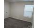 A bedroom with neutral carpeting, a window with blinds, and a closet at 586 30Th Avenue Ne Cir, Hickory, NC 28601