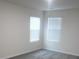 A light-filled bedroom featuring neutral carpeting and two bright windows at 586 30Th Avenue Ne Cir, Hickory, NC 28601