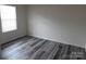 Bright bedroom features wood-look flooring and a window with natural light at 586 30Th Avenue Ne Cir, Hickory, NC 28601
