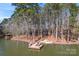 Aerial view of a house with a dock, chairs, and fire pit at 693 Emerald Shores Rd, Mount Gilead, NC 27306
