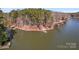 Aerial view of a wooded area and lake with docks at 693 Emerald Shores Rd, Mount Gilead, NC 27306