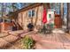 Back deck with brick siding, patio table with red umbrella, and steps to yard at 693 Emerald Shores Rd, Mount Gilead, NC 27306