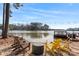 Scenic backyard with chairs overlooking the serene lake at 693 Emerald Shores Rd, Mount Gilead, NC 27306