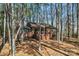 Brick home featuring a deck and patio, surrounded by mature trees and fencing at 693 Emerald Shores Rd, Mount Gilead, NC 27306