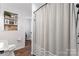 Beautiful bathroom featuring modern white tile, hardwood floors, and a shower with a grey curtain at 693 Emerald Shores Rd, Mount Gilead, NC 27306