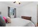Bright bedroom featuring hardwood floors, a window with black and white curtains, and a vintage dresser at 693 Emerald Shores Rd, Mount Gilead, NC 27306