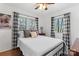 Charming bedroom with hardwood floors, two large windows, and elegant black and white curtains at 693 Emerald Shores Rd, Mount Gilead, NC 27306