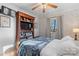 Comfortable bedroom with floral wallpaper, wood built-ins, and a ceiling fan at 693 Emerald Shores Rd, Mount Gilead, NC 27306