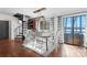 Bright dining room featuring a spiral staircase, lake views, and a modern chandelier at 693 Emerald Shores Rd, Mount Gilead, NC 27306