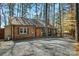 Cozy brick home with a gravel driveway, nestled in a wooded area with rustic charm at 693 Emerald Shores Rd, Mount Gilead, NC 27306