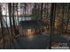 Inviting brick home with warm lighting and a partially visible lake view for evening appeal at 693 Emerald Shores Rd, Mount Gilead, NC 27306