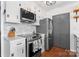 Kitchen featuring a stainless steel oven and microwave, white countertops and painted cabinets at 693 Emerald Shores Rd, Mount Gilead, NC 27306