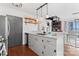 Kitchen featuring a sink island with white countertops, stainless steel appliances and a spiral staircase at 693 Emerald Shores Rd, Mount Gilead, NC 27306
