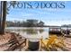 Scenic lake view featuring two docks, shoreline seating, and waterfront ambiance at 693 Emerald Shores Rd, Mount Gilead, NC 27306