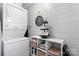 Functional laundry room with a stacked washer and dryer and a shelving unit for storage at 693 Emerald Shores Rd, Mount Gilead, NC 27306