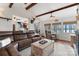Spacious living room with beamed ceilings, hardwood floors, and an open layout at 693 Emerald Shores Rd, Mount Gilead, NC 27306