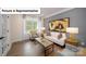 Bright living room featuring hardwood floors, modern furniture, neutral paint, and French doors at 7027 Sylvan Retreat Dr, Denver, NC 28037