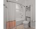 Clean, bright bathroom with white fixtures, a shower-tub combo, and storage at 7127 Chrysanthemum Rd, Lancaster, SC 29720