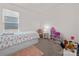 Bright bedroom with bed and storage plus toys and a cute chair and small table at 7127 Chrysanthemum Rd, Lancaster, SC 29720