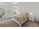Bright bedroom features neutral decor, ensuite access, and plenty of natural light at 7127 Chrysanthemum Rd, Lancaster, SC 29720