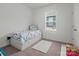 Bright bedroom with a bed that has built-in drawers and a soft, carpeted floor at 7127 Chrysanthemum Rd, Lancaster, SC 29720