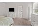 Spacious bedroom includes a tv, modern dresser, and ensuite access at 7127 Chrysanthemum Rd, Lancaster, SC 29720