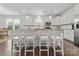 Well-lit kitchen with white cabinets, granite countertops, and seating at the island at 7127 Chrysanthemum Rd, Lancaster, SC 29720