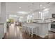 Open-concept kitchen with white cabinetry, a granite island, and modern pendant lighting at 7127 Chrysanthemum Rd, Lancaster, SC 29720