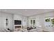 Bright living room with a modern fireplace, sleek furniture, large windows, and elegant curtains with a view of the lake at 7443 Paddle Ln # 55, Sherrills Ford, NC 28673
