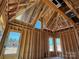 Interior of a new build's attic shows stud framing and the wooden support beams at 7459 Fighting Creek Rd # 33, Sherrills Ford, NC 28673
