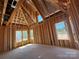 Bare interior of an unfinished attic, showcasing window framing and exposed rafter beams at 7459 Fighting Creek Rd # 33, Sherrills Ford, NC 28673