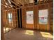 Unfinished bedroom featuring framing, windows, and sunlight, highlighting the initial construction phase at 7459 Fighting Creek Rd # 33, Sherrills Ford, NC 28673