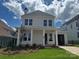 Inviting two-story home showcasing a charming front porch with classic white columns at 7459 Fighting Creek Rd # 33, Sherrills Ford, NC 28673