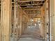 The unfinished hallway shows exposed studs and framing, awaiting drywall and other finishes at 7459 Fighting Creek Rd # 33, Sherrills Ford, NC 28673