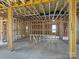 A spacious unfinished living room revealing the stud walls, and overhead ductwork awaiting completion at 7459 Fighting Creek Rd # 33, Sherrills Ford, NC 28673