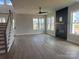 Spacious living room with fireplace, modern fan, and lots of natural light from large windows at 7459 Fighting Creek Rd # 33, Sherrills Ford, NC 28673