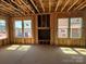 Living room under construction with a fireplace and multiple windows showing new construction at 7459 Fighting Creek Rd # 33, Sherrills Ford, NC 28673