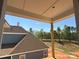 View from the porch overlooking the adjacent rooftops and green tree line at 7459 Fighting Creek Rd # 33, Sherrills Ford, NC 28673