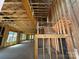 Unfinished interior framing with a staircase leading to an upper level with exposed rafters at 7459 Fighting Creek Rd # 33, Sherrills Ford, NC 28673