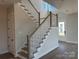 Bright foyer features beautiful staircase with hardwood treads, white risers, and craftsman style banister at 7459 Fighting Creek Rd # 33, Sherrills Ford, NC 28673