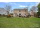 Expansive backyard featuring a well-maintained lawn and a patio with outdoor seating for relaxation and recreation at 9117 Spratt Ln, Waxhaw, NC 28173