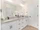 Bathroom with double vanity, granite countertops, white cabinets, and modern fixtures at 9503 Weston Woods Ln, Charlotte, NC 28216