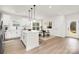 Modern kitchen with an island, stainless steel appliances, and an adjacent dining area at 9503 Weston Woods Ln, Charlotte, NC 28216