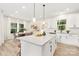 Bright kitchen with modern appliances and an island that overlooks a dining space at 9503 Weston Woods Ln, Charlotte, NC 28216