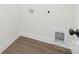 A tidy laundry room features modern wood-look floors, new walls, and clearly labeled utility connections at 9503 Weston Woods Ln, Charlotte, NC 28216