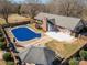 Aerial view of the brick home with a pool, gazebo, fenced-in yard, patio and mature trees at 102 3Rd Se Ave, Catawba, NC 28609