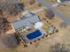 Aerial view of private backyard featuring a covered pool, a patio, and mature trees at 102 3Rd Se Ave, Catawba, NC 28609